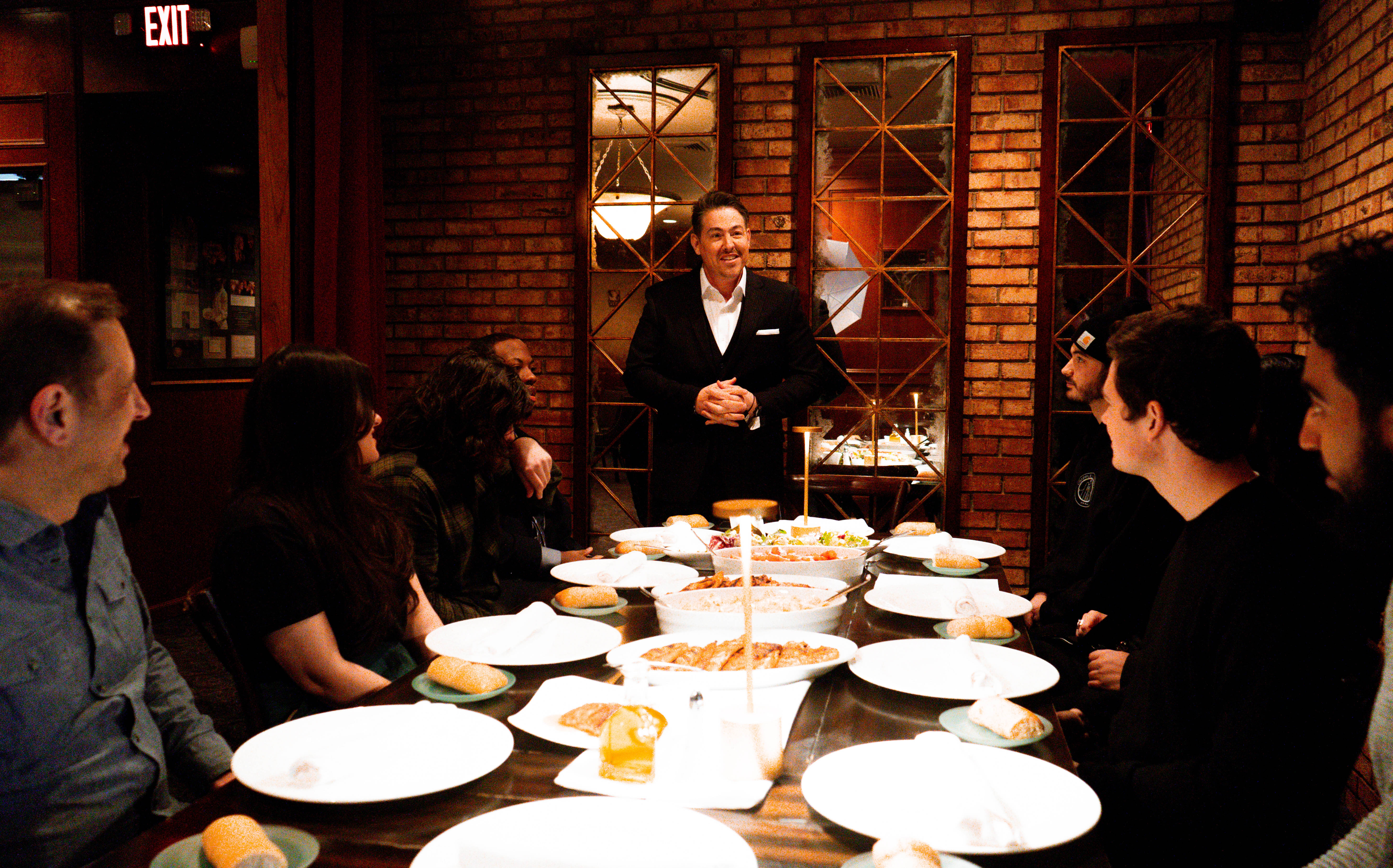 Adrian Tonon welcoming a group of guests at his restaurant